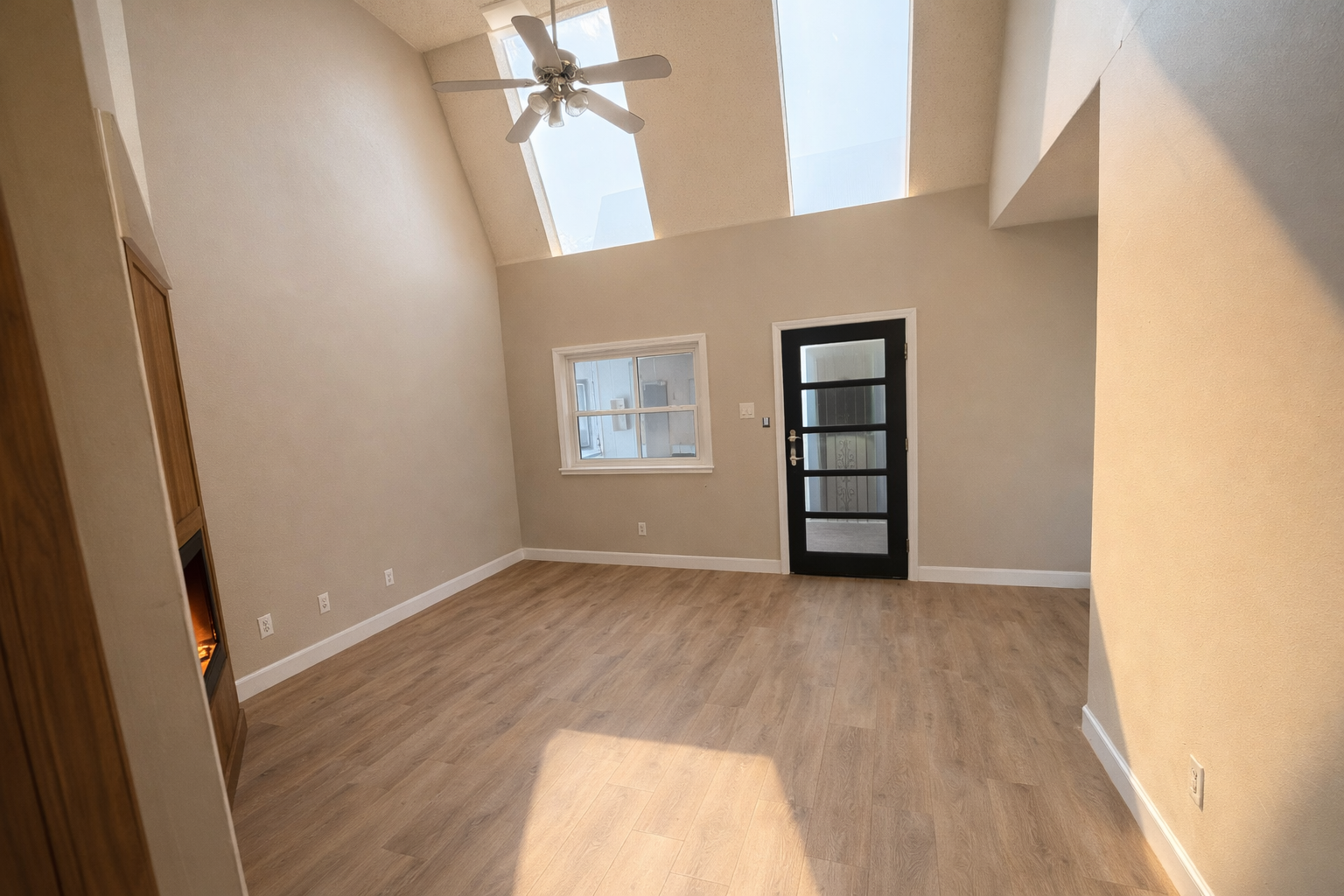 Bedroom with skylights and glass-paned door